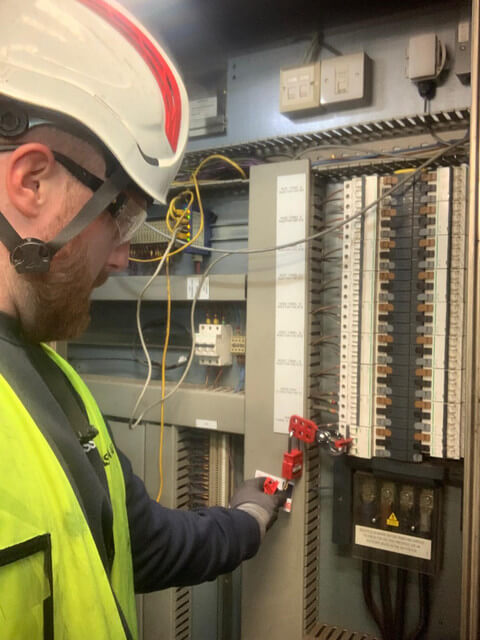 Electrician securing an electrical panel